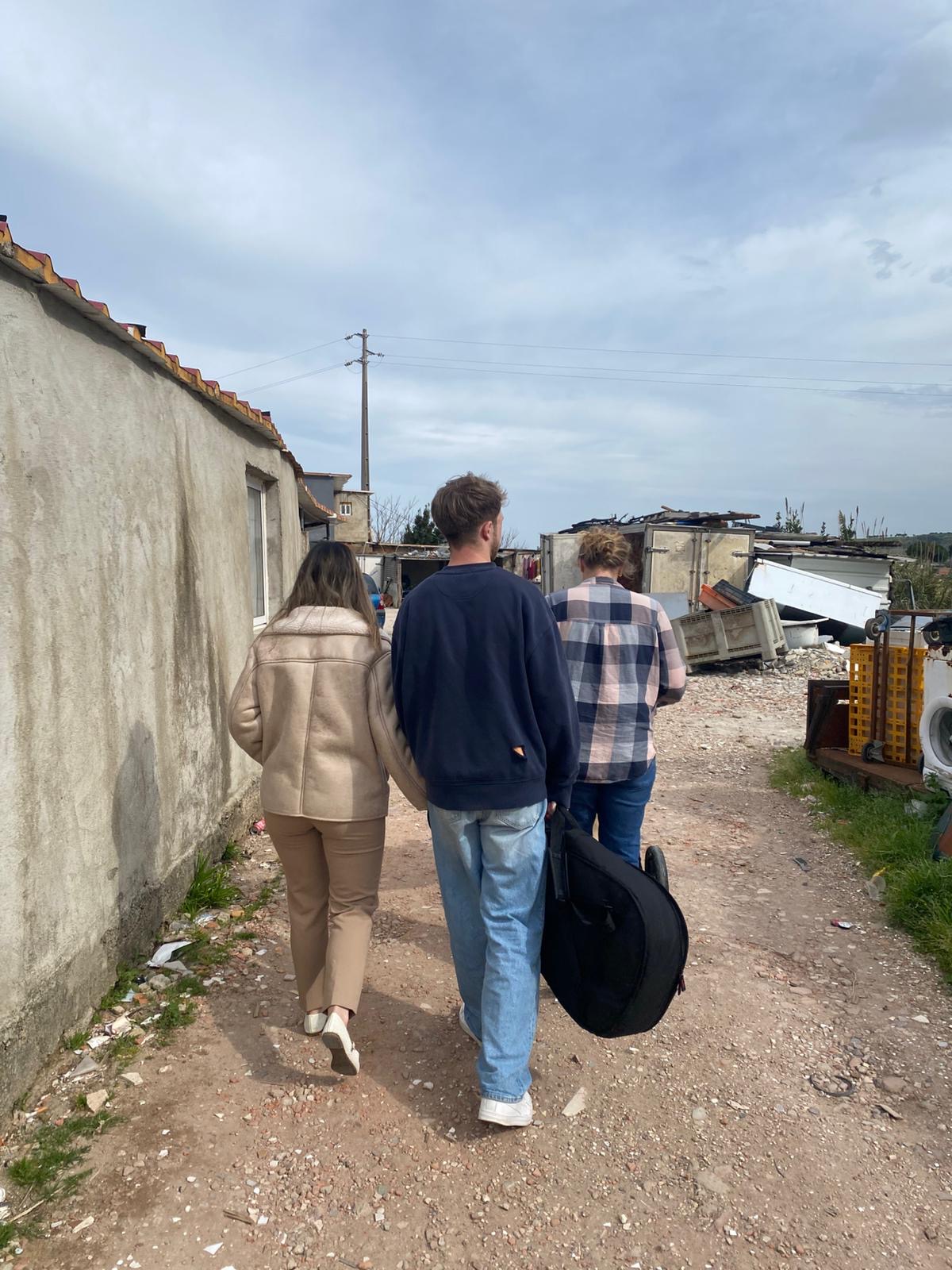 Walking through a neighbourhood with a guitar