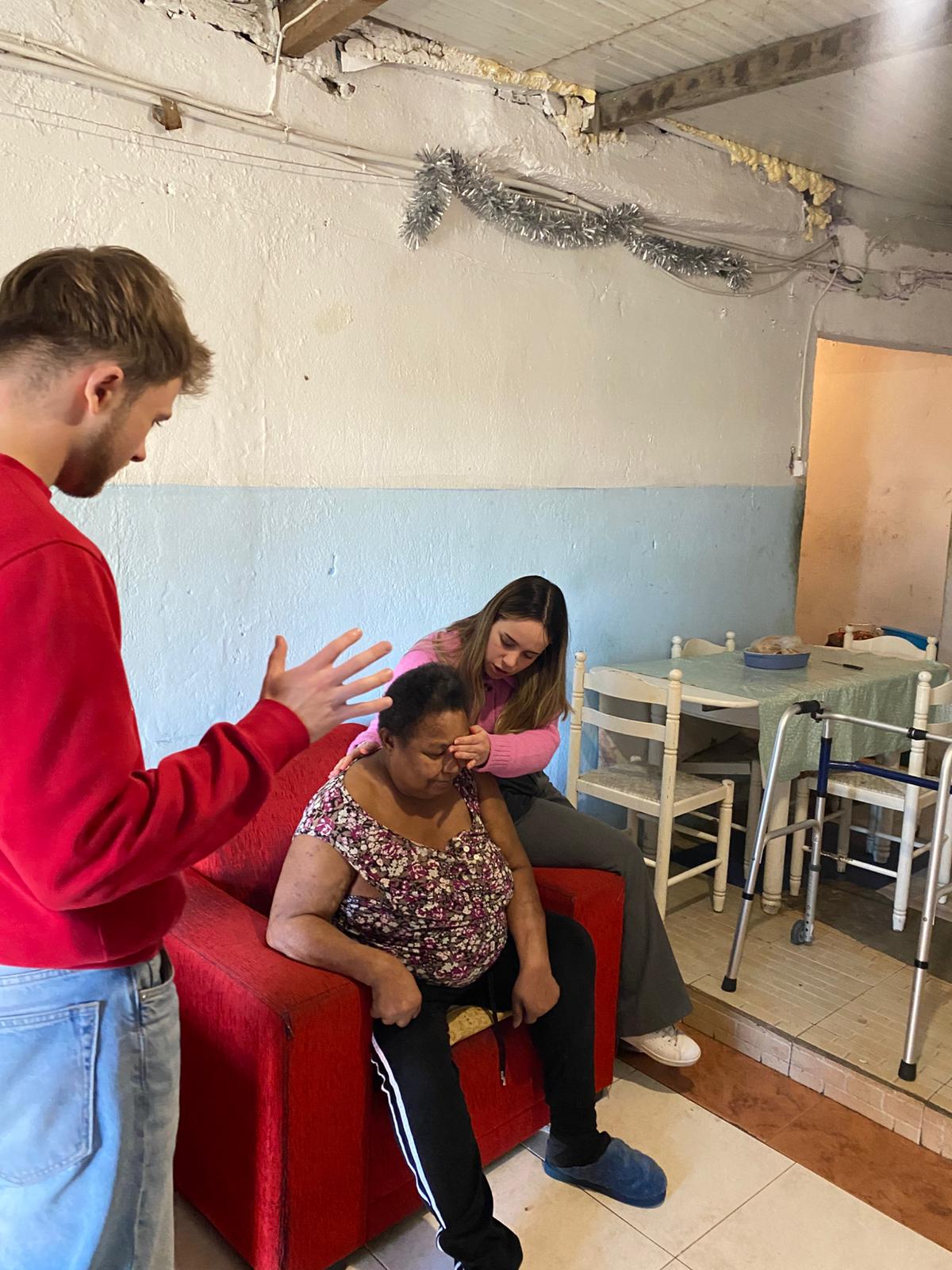 Praying with a woman in her home